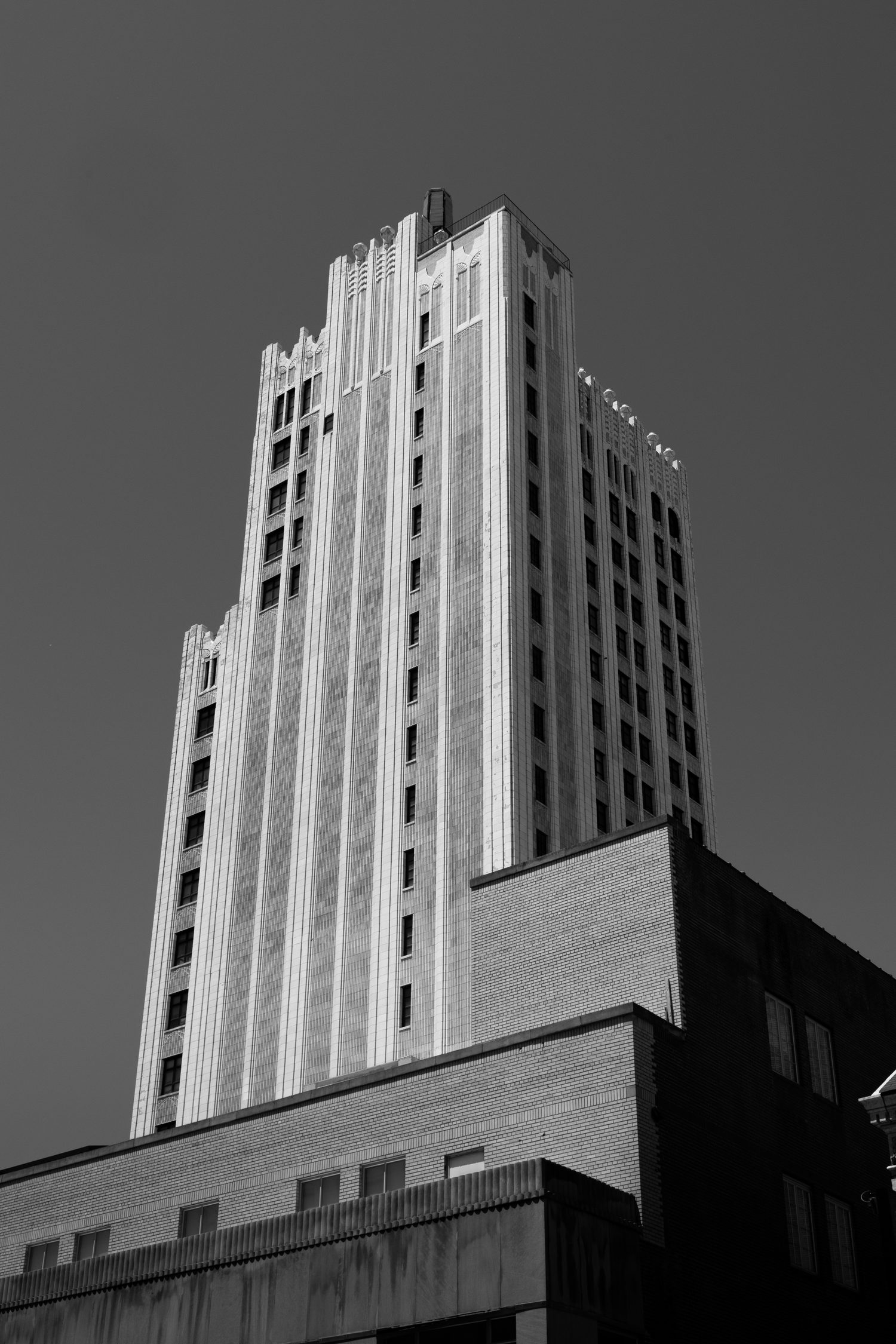 Black and white photo of an Art Deco skyscraper tower reaching into the sky